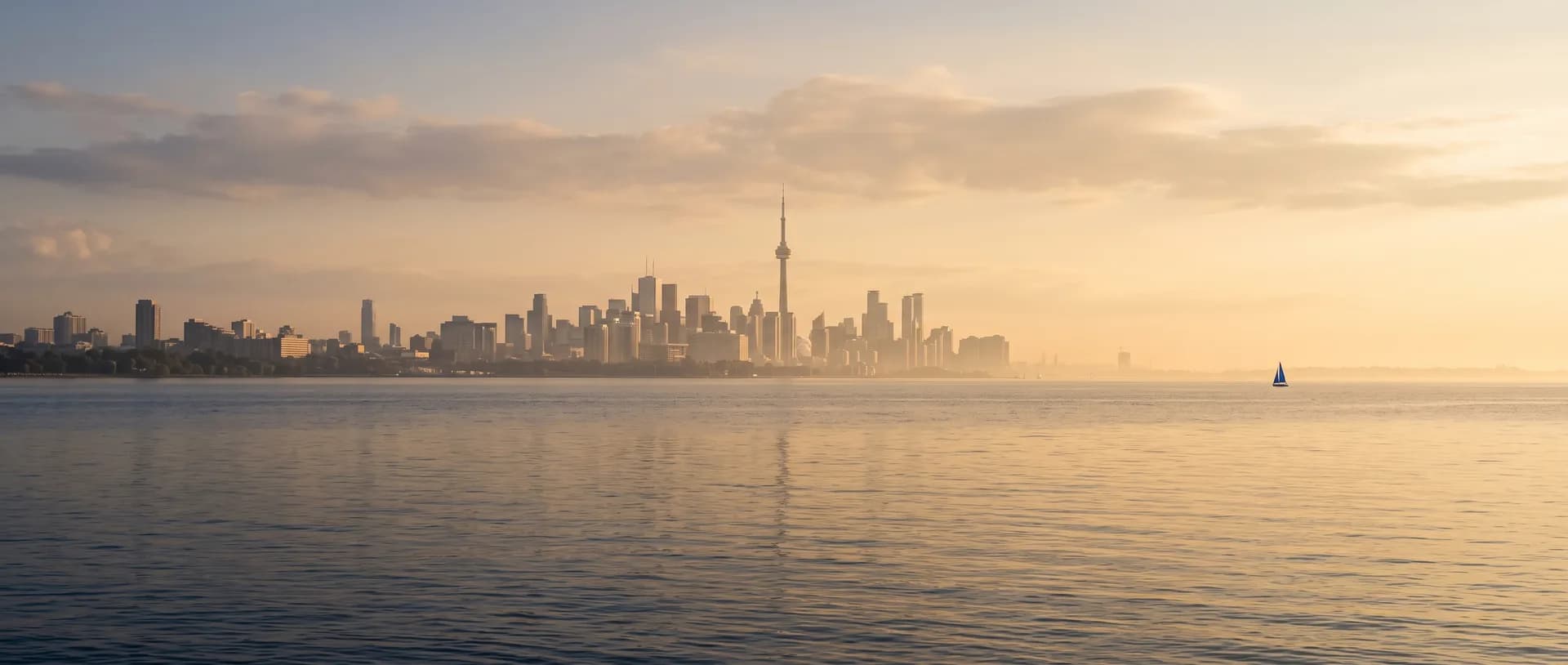 The Toronto skyline across Lake Ontario at golden hour